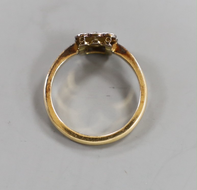 A 1920's 18ct and nine stone diamond cluster set tablet ring, size R, gross weight 4 grams.